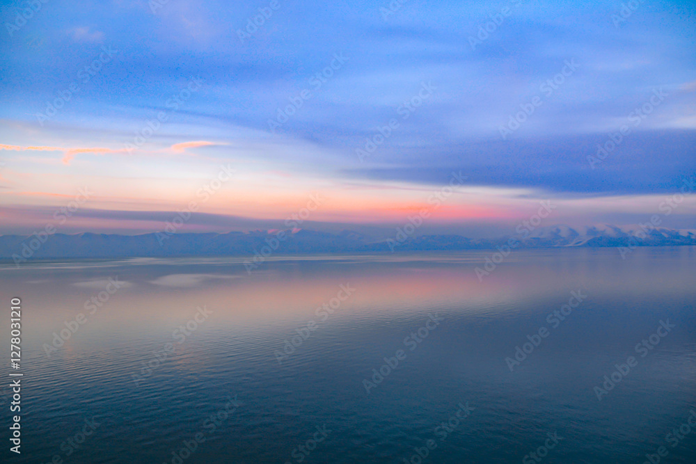 Beautiful sunset over the lake. Sunrise on the sea. Beautiful landscape with lake, mountains and sunset. Reflection in the water Beautiful sunset over the lake. Sunrise on the sea. Beautiful landscape with lake, mountains and sunset. Reflection in the water