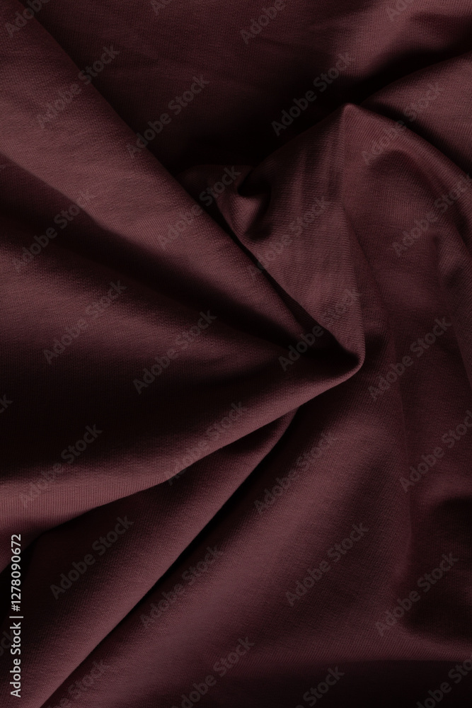Obraz premium Close-up of burgundy fabric, showing soft textures and folds. Ideal for backgrounds or showcasing textiles with a rich, warm color.