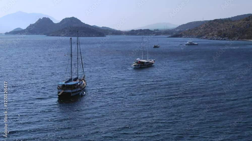 Sailboats moored in blue and deep waters, Karaincir beach, Turkey. Aerial drone, copy space Sailboats moored in blue and deep waters, Karaincir beach, Turkey. Aerial drone, copy space