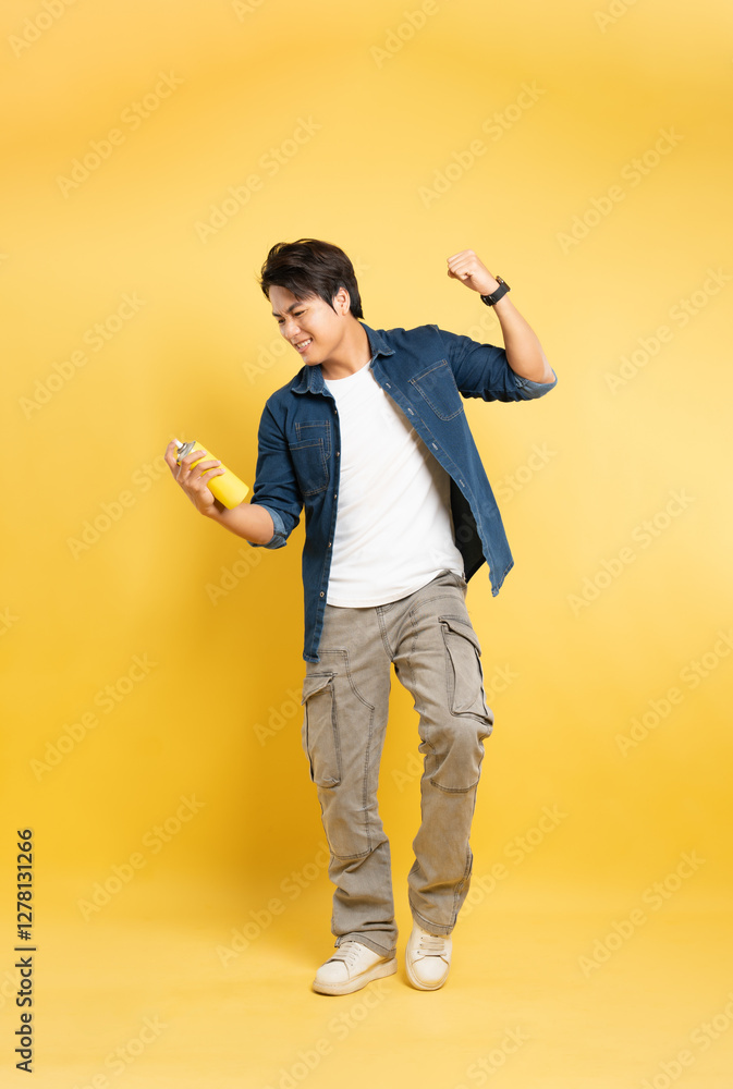 portrait of a man holding a paint vase posing on a yellow background, portrait of a man holding a paint vase posing on a yellow background,
