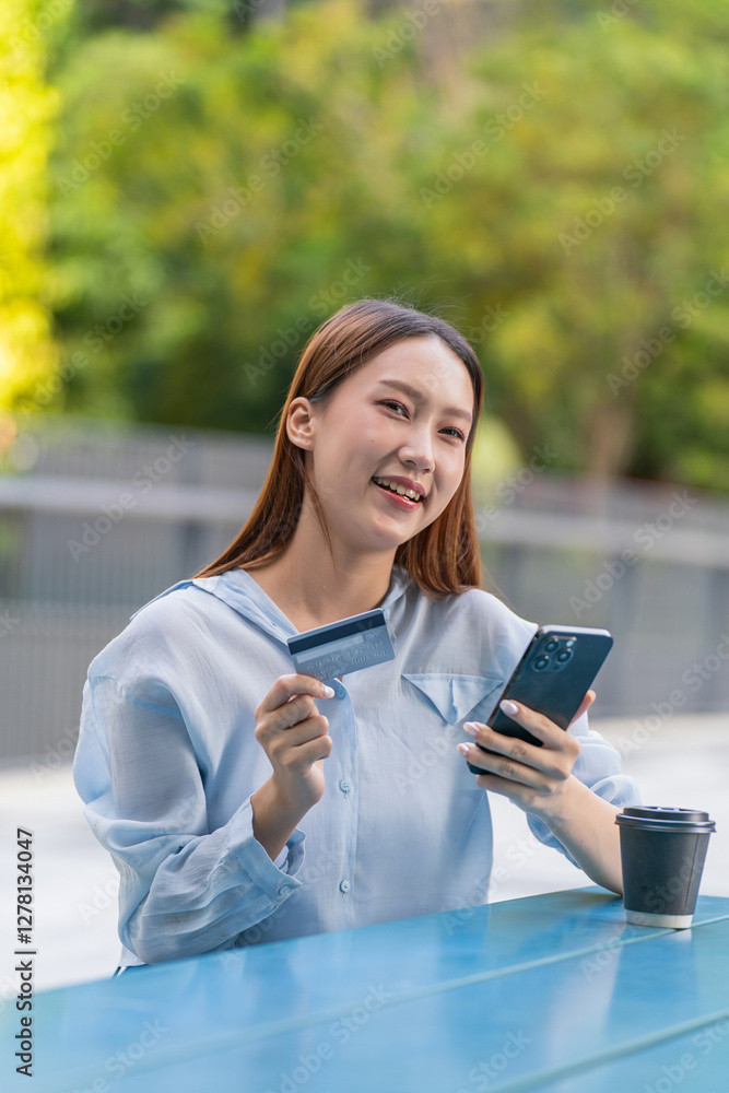 Asian Woman Using Phone and Credit Card Outdoors a Modern Greenery Office Building Asian Woman Using Phone and Credit Card Outdoors a Modern Greenery Office Building