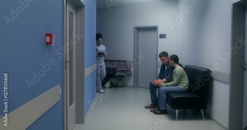 Foto Relatives are waiting for the operation result, sitting in the hospital corridor
