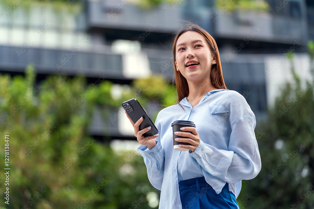 Asian Businesswoman In Casual Business Outfit Holding Coffee and Using Phone In Front of a Modern Office Building in the Financial District Asian Businesswoman In Casual Business Outfit Holding Coffee and Using Phone In Front of a Modern Office Building in the Financial District