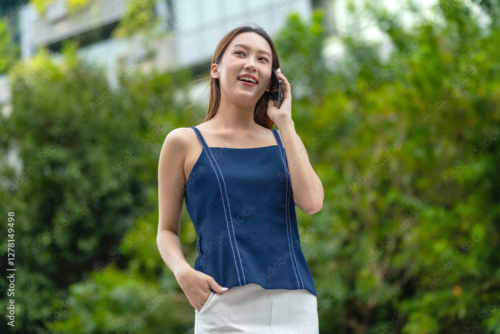 Young Asian Businesswoman In Casual Business Outfit Using Phone Outdoors In Front a Modern Office Building Young Asian Businesswoman In Casual Business Outfit Using Phone Outdoors In Front a Modern Office Building
