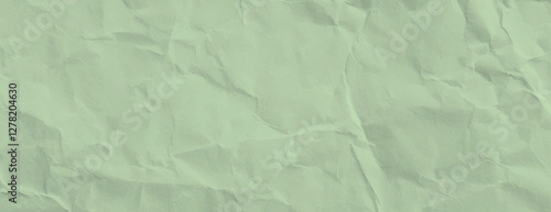 A crumpled paper background with a light green color. The background has a textured, wrinkled appearance with a soft green hue. Paper texture background vector. Green background.