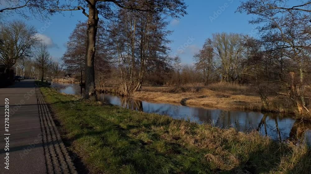 Golden hour walk, peaceful river scenes in the dutch countryside - Giethoorn, Netherlands Golden hour walk, peaceful river scenes in the dutch countryside - Giethoorn, Netherlands