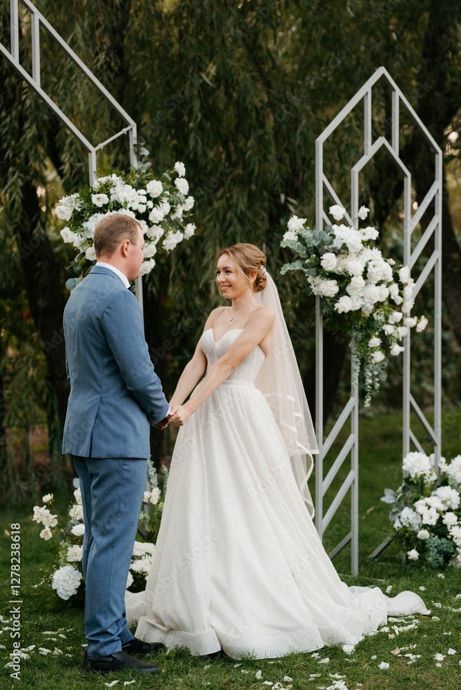wedding ceremony of the newlyweds on the glade