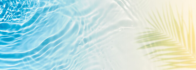 abstract sand beach with blue transparent water wave and palm leaf shadow on sunny tropical background banner, beautiful nature scene with copy space for travel, vacation and beauty spa 