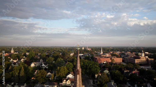 Parallax drone shot of Trinity Lutheran Church bell tower at sunrise in Monroe, Michigan, USA photo