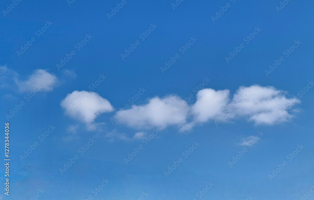 clouds resembling a large caterpillar
small white clouds lined up one after another in a curved line on the blue sky clouds resembling a large caterpillar
small white clouds lined up one after another in a curved line on the blue sky