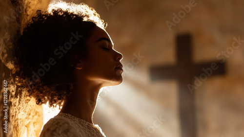 Hope in Shadows: A serene moment captures a woman with closed eyes, bathed in the soft glow of sunlight streaming through a window. A cross on the wall gently reminds the viewer of the power of faith.
