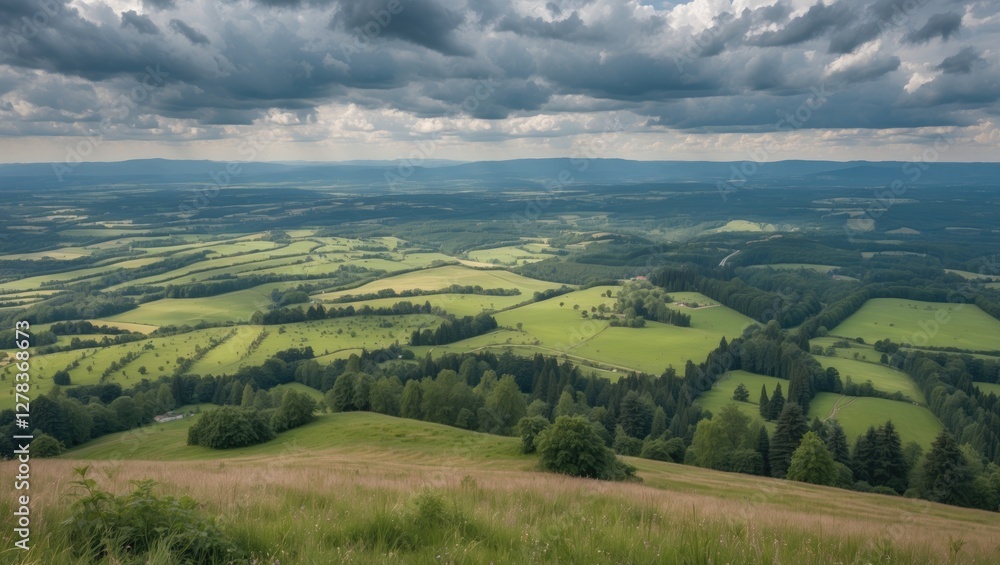 Panoramic View From Hilltop Overlooking Lush Meadows Forests And Fields Beneath Dramatic Cloudy Sky During Summer Hiking Adventure Panoramic View From Hilltop Overlooking Lush Meadows Forests And Fields Beneath Dramatic Cloudy Sky During Summer Hiking Adventure