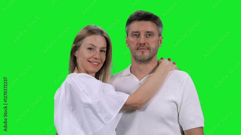 Portrait of adult loving couple looking at camera on green chroma key background, 4k pre-keyed footage Portrait of adult loving couple looking at camera on green chroma key background, 4k pre-keyed footage