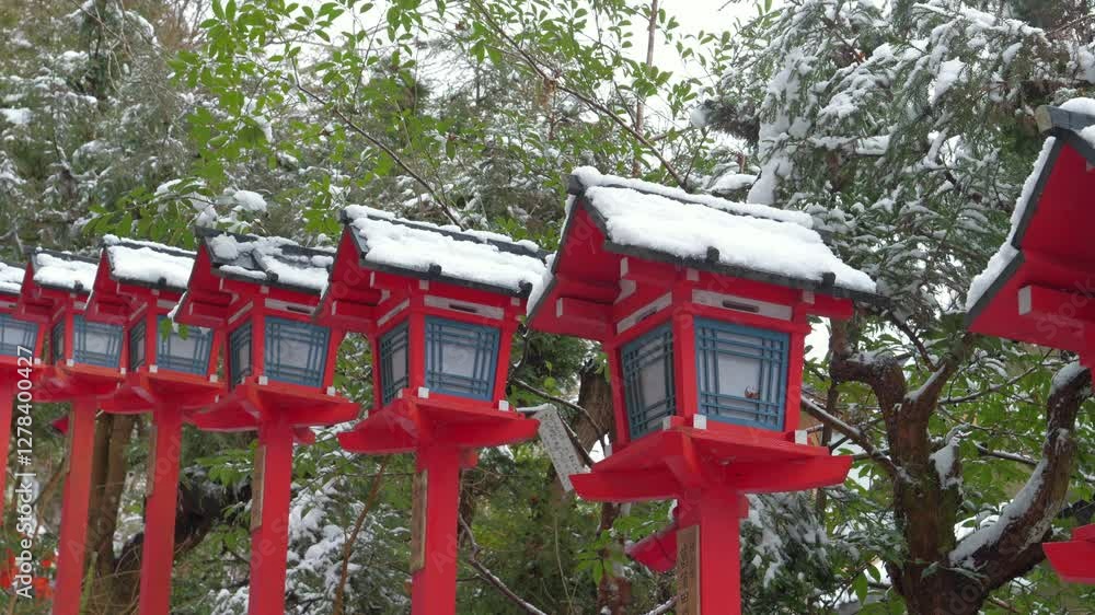 Lanterns at a Japanese shrine in winter, covered with snow. Lanterns at a Japanese shrine in winter, covered with snow.