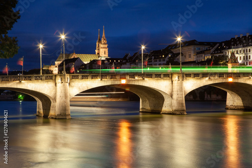 Obraz na płótnie Long exposure 'Mittlere Brucke' river bridge and Gross Basel Muenster cathedral spanning the Rhine River in Basel illuminated a dusk w salonie