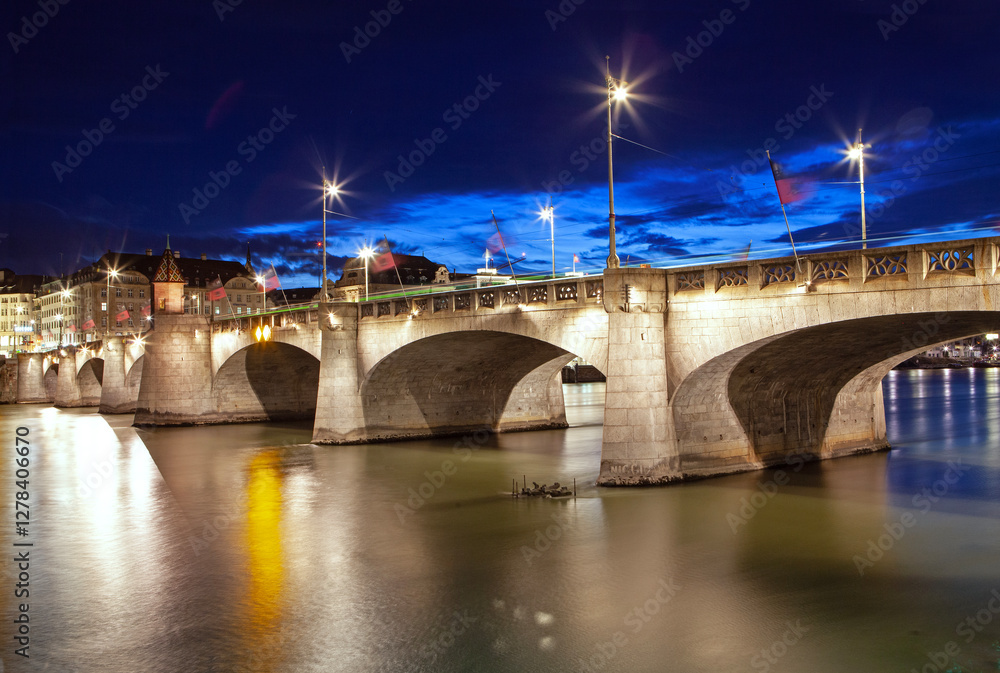 Long exposure 'Mittlere Brucke' river bridge spanning the Rhine River in Basel illuminated a dusk