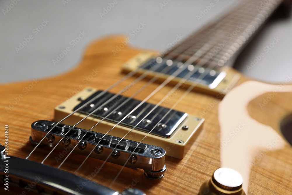 Obraz premium Modern electric guitar on grey background, closeup