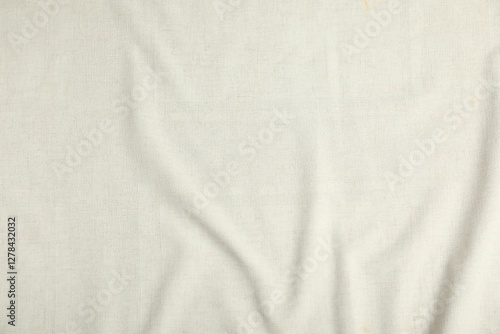 Fotografie Texture of beige crumpled tablecloth as background, top view