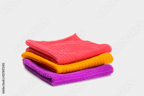 Three multi-colored household dust cloths on a white background