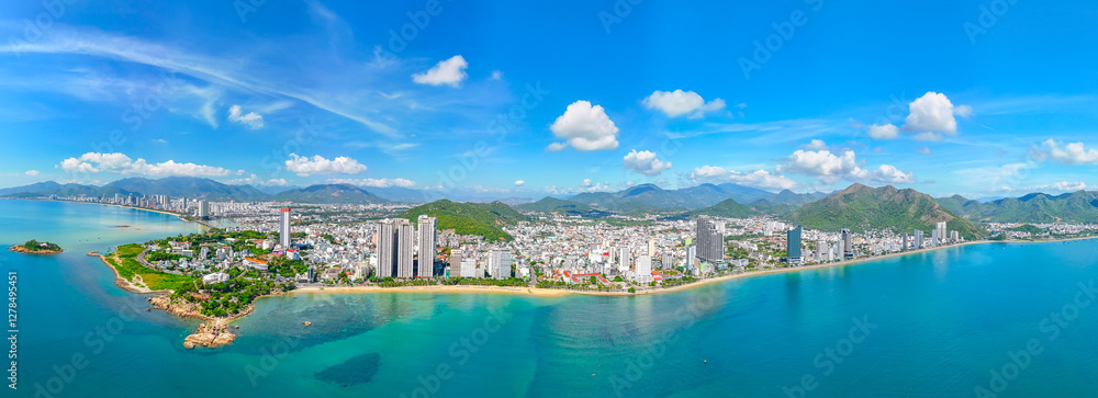 Naklejka premium Beach overlooking panoramic aerial view city on the coast cliff of Southeast Asia in the bright morning sunrise Nha Trang