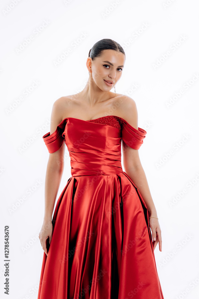 Sexy brunette girl in a red luxury fashion dress on a white background Sexy brunette girl in a red luxury fashion dress on a white background