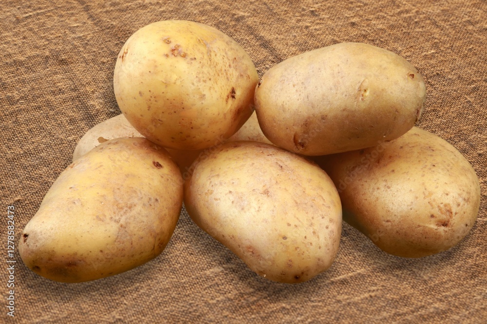 Ripe fresh potatoes on wooden desk Ripe fresh potatoes on wooden desk