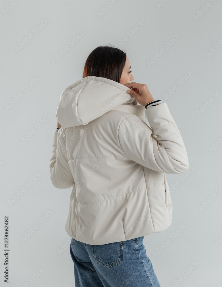 Portrait of a cute girl model in a leather white jacket and striped sweater Portrait of a cute girl model in a leather white jacket and striped sweater