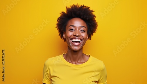 Cheerful woman smiling in yellow shirt on bright yellow background, positive energy concept
