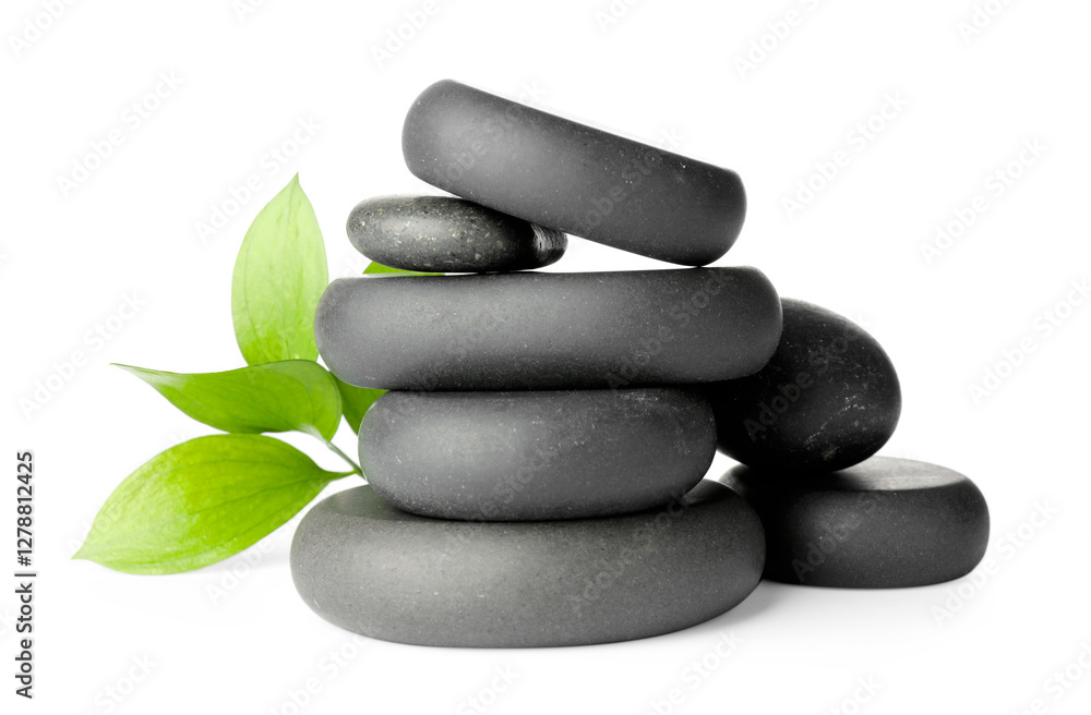 Stacked spa stones and green leaves isolated on white Stacked spa stones and green leaves isolated on white