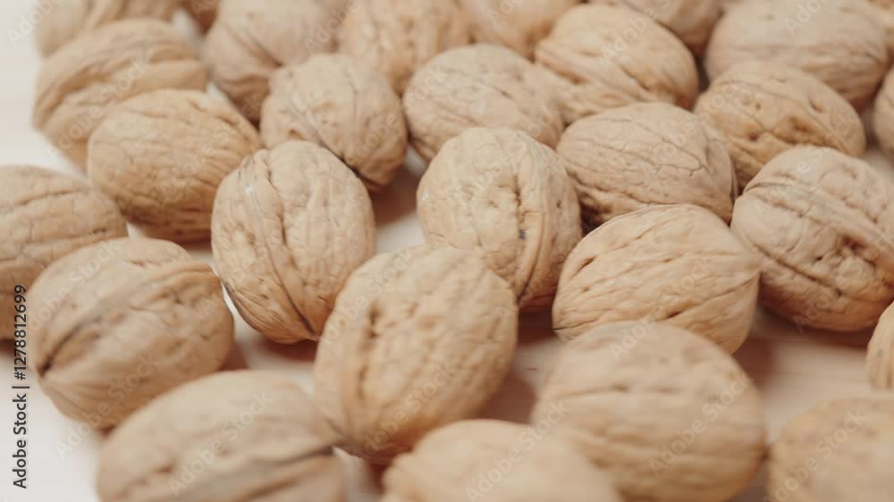 Close-up image showcasing a collection of raw whole walnuts with their textured shells, emphasizing natural nutrition and health-focused food concepts, illustrating healthy eating and natural dried nu Close-up image showcasing a collection of raw whole walnuts with their textured shells, emphasizing natural nutrition and health-focused food concepts, illustrating healthy eating and natural dried nu