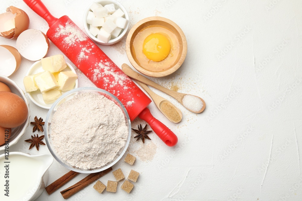 Rolling pin and different ingredients on white table, flat lay. Space for text Rolling pin and different ingredients on white table, flat lay. Space for text