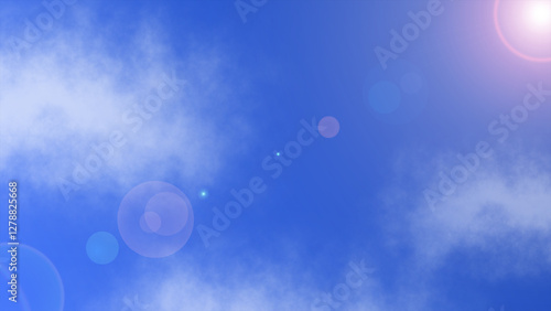 A clear blue sky with scattered clouds and a bright lens flare effect, creating a serene and radiant atmosphere