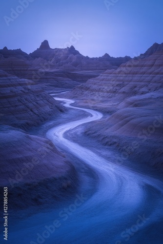 Obraz na płótnie Smooth river winds through surreal desert landscape under twilig w salonie