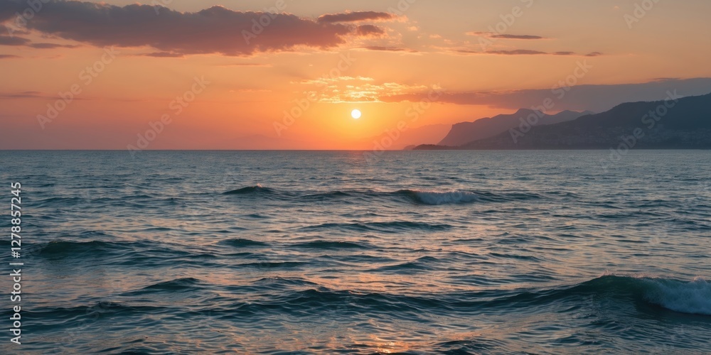 Sunset over calm sea with gentle waves and silhouette of mountains in the background under a colorful sky Sunset over calm sea with gentle waves and silhouette of mountains in the background under a colorful sky