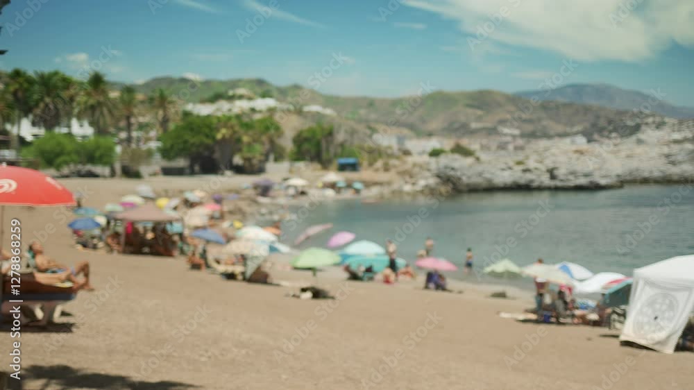 Blurred summer beach with silhouettes of people and sun umbrellas in the summer day. Blurred summer beach with silhouettes of people and sun umbrellas in the summer day.