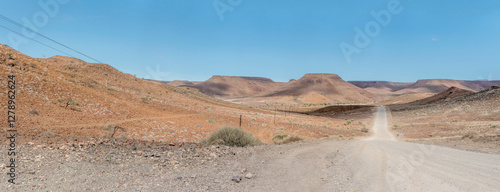 Obraz na płótnie C39 dirt road uphill and downhill in desert, near Bergsig, Namibia w salonie