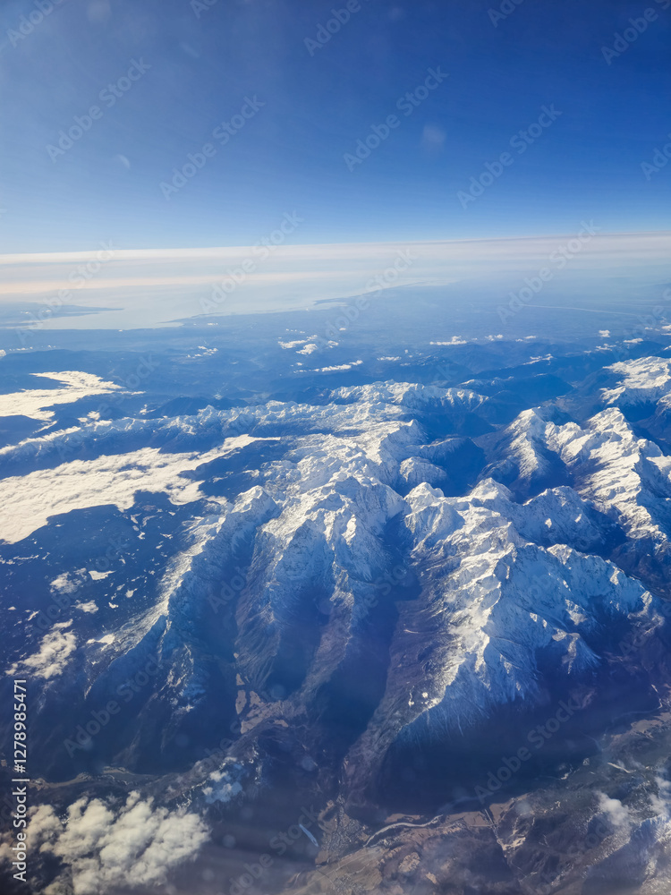 Fototapeta premium Aerial view of the mountains from an aircraft.