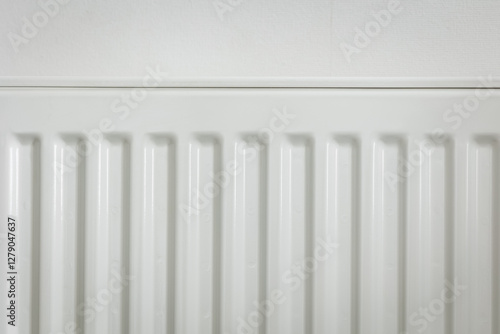 Wallpaper Mural Close-up of a white metal radiator with a temperature control valve. Modern home heating system, energy efficiency concept. Minimalistic interior with clean lines and functional design Torontodigital.ca