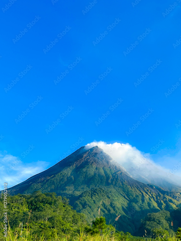 beautiful view of mount merapi against blue sky and white cloud beautiful view of mount merapi against blue sky and white cloud