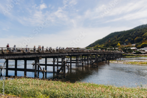 Arashiyama district panorama in western Kyoto, Japan, with boats and mountain Arashi, Togetsukyo bridge, Katsura Hozu River, autumn fall landscape view, travel to Japan, Kansai region, Kyoto photo