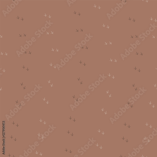 Bird footprints on a toffee brown background 