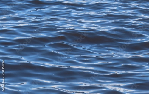 Rolling waves on blue river water surface, natural background