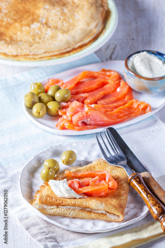 Obraz na płótnie Pancakes with gravlax, cottage cheese and olives. A traditional dish for Maslenitsa or Carnival. w salonie