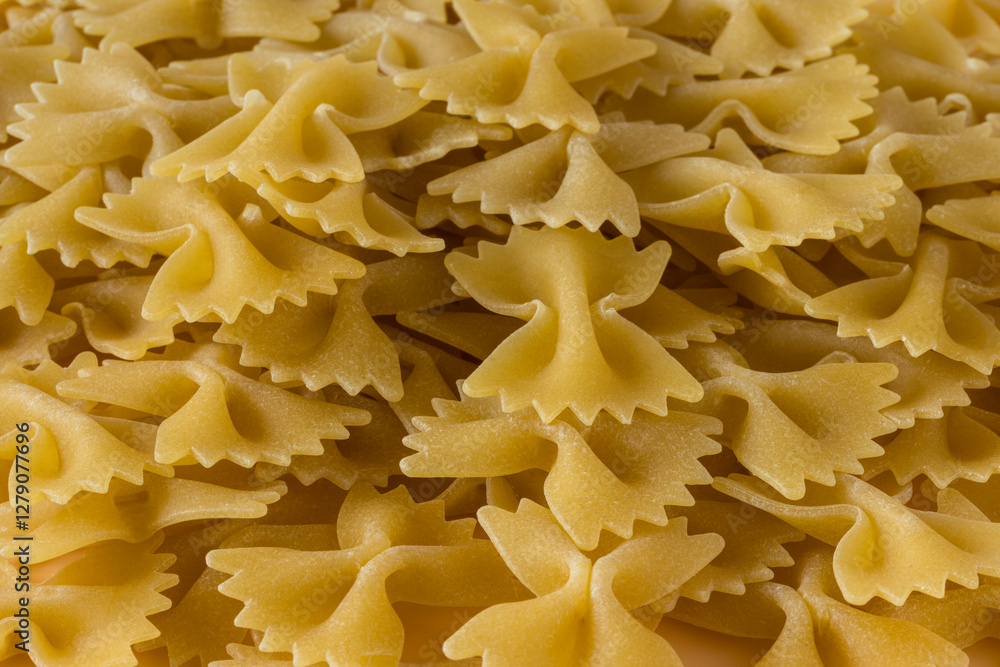 Side view , close-up of a raw italian durum wheat farfalle pasta . Side view , close-up of a raw italian durum wheat farfalle pasta .