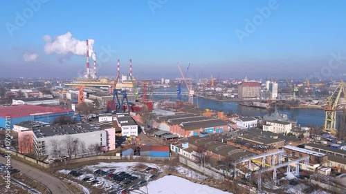 Aerial View of an Industrial Harbor Cityscape Featuring Containers, Cranes, and Shipyards
