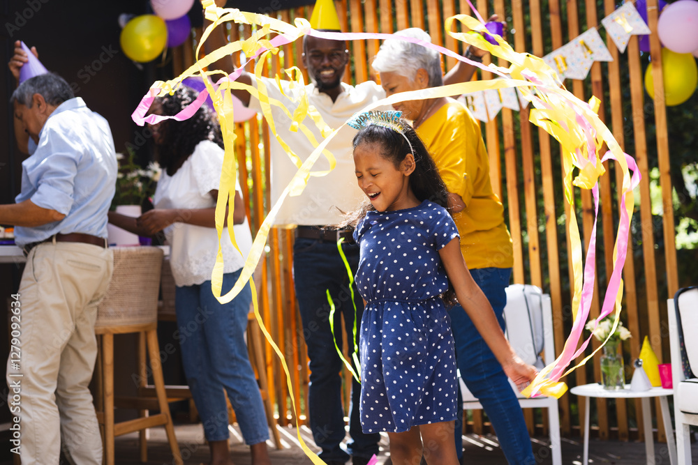 custom made wallpaper toronto digitalYoung girl joyfully dancing with streamers at lively diverse family celebration in garden