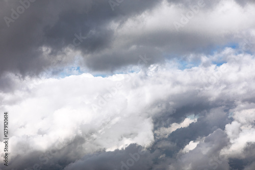 Obraz na płótnie Vast expanse of cumulus clouds, showcasing a mix of light and shadow. Layers of puffy white and gray clouds, hinting at a dynamic sky. Cloudy sky, with a mix of light and dark gray clouds w salonie
