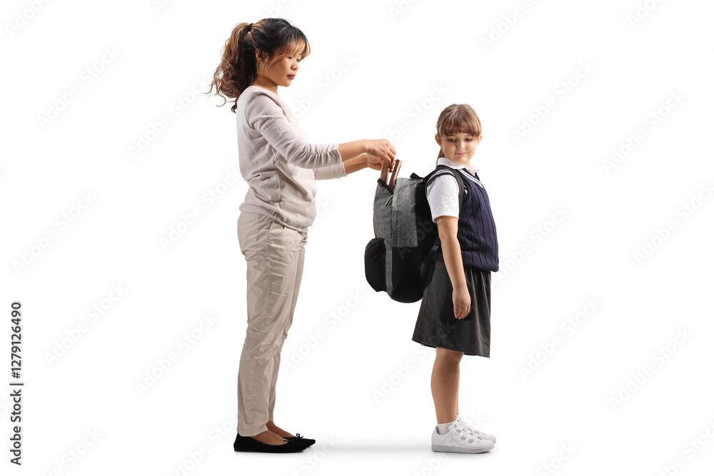 Asian woman helping a girl with school backpack Asian woman helping a girl with school backpack