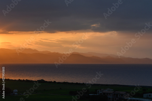 Wallpaper Mural Golden sunset illuminates distant mountains over tranquil sea landscape in vibrant evening sky Torontodigital.ca