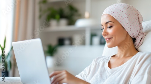 Brave woman works on her laptop while facing cancer journey